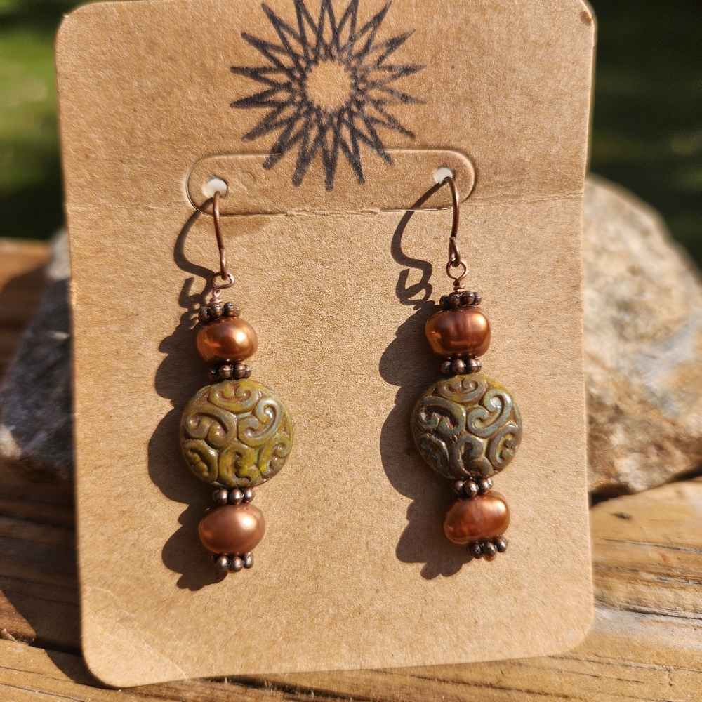 Bronze fresh water pearl and green tinted carved bead earrings.